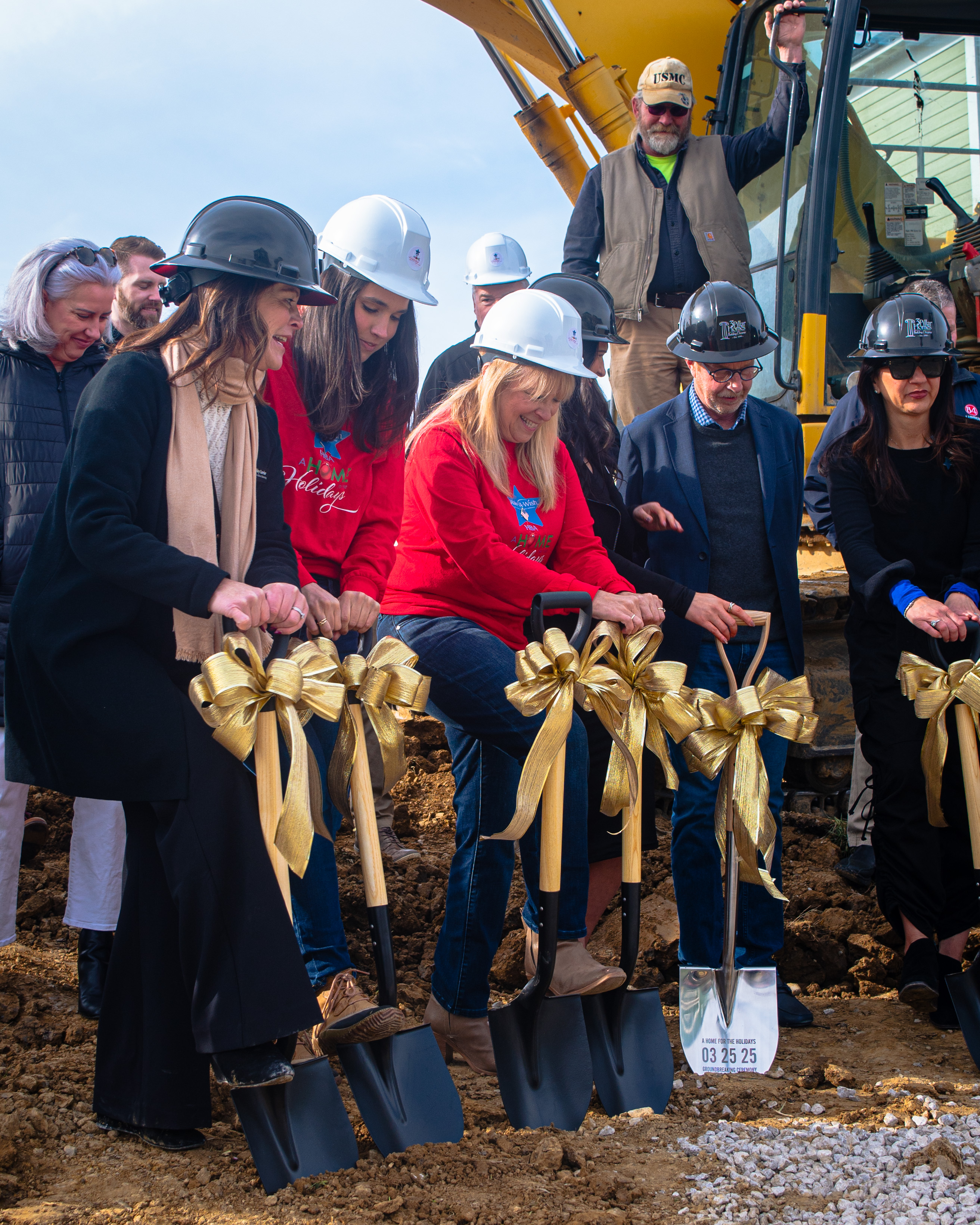 Shoveling into the ground at building ceremony
